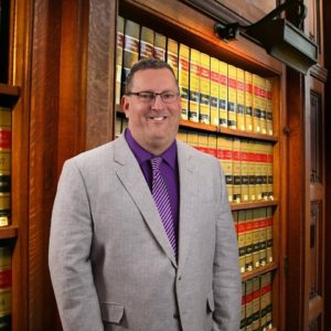 Attorney standing in a law office library