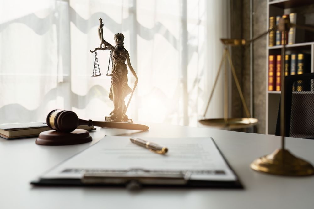 Justice statue beside a courtroom gavel