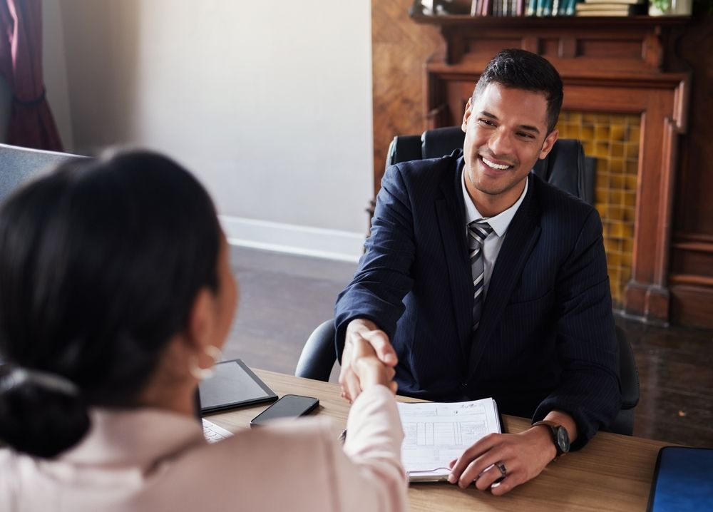 Attorney and client shaking hands during a consultation