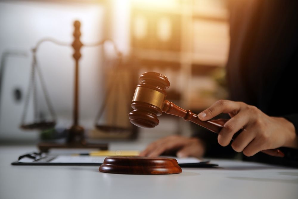 Courtroom gavel striking its sound block