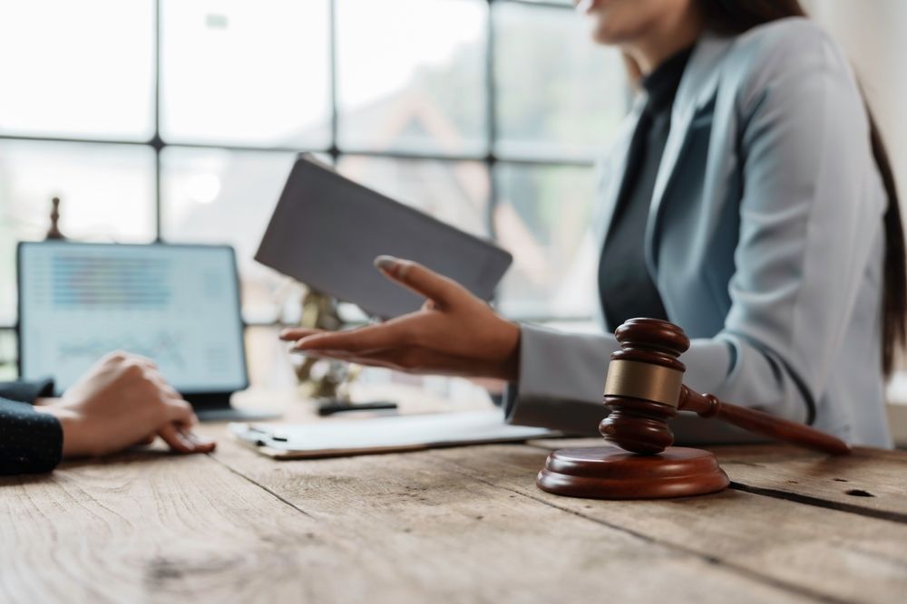 Client handing documents to a Michigan license restoration attorney